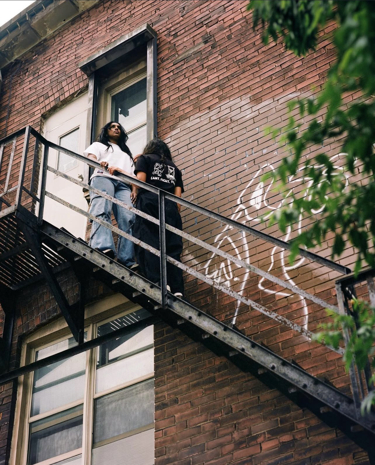 Two models on a Toronto fire escape — Latter Days 'Awakening' campaign.