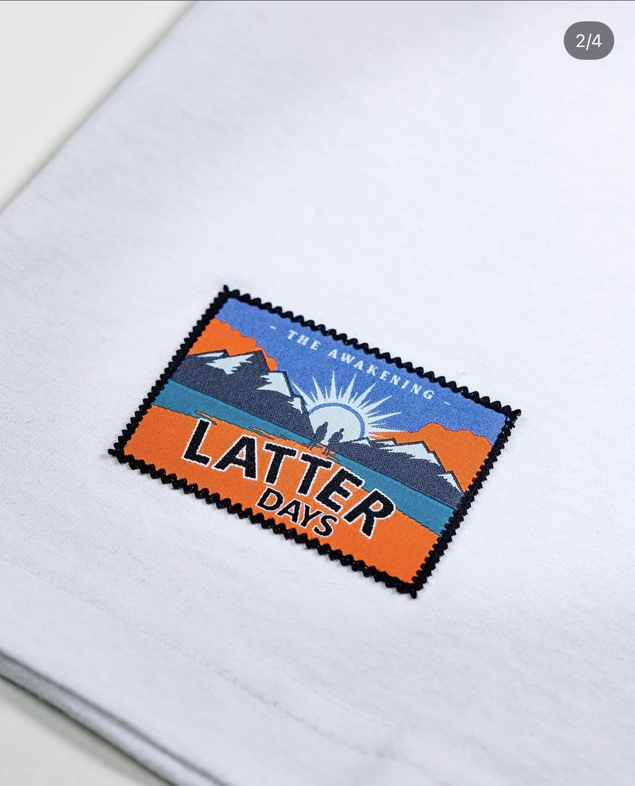 Awakening capsule stamp logo printed on a tee.